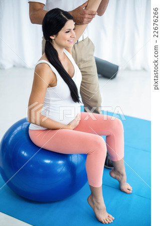 Doctor giving physiotherapy to pregnant woman 22676266