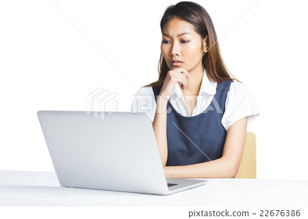 Doubtful businesswoman using a laptop 22676386