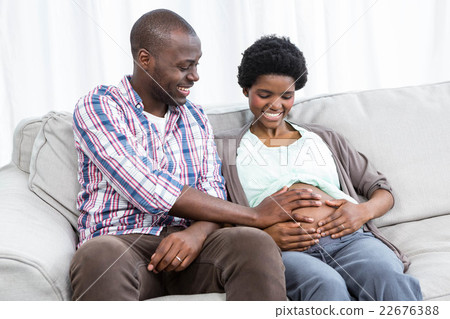 Man touching pregnant womans stomach 22676388