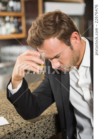 Tired man having a whiskey 22676476