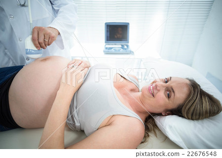 Pregnant woman receiving ultrasound treatment 22676548