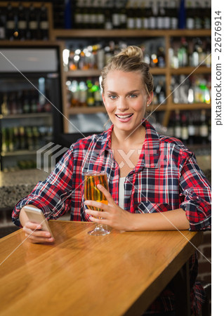 Pretty woman using smartphone and having a beer Pretty woman using smartphone and having a beer 22676914