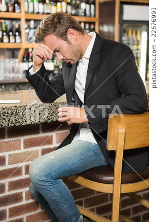 Tired man having a whiskey 22676991