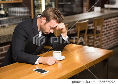 Handsome man looking at smartphone and having a coffee 22677092