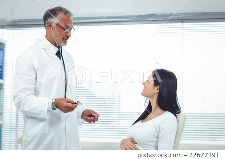 Doctor examining pregnant woman with a stethoscope Doctor examining pregnant woman with a stethoscope 22677191