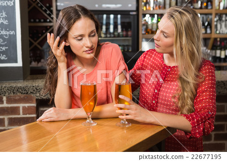 Cute friends having a glass of beer Cute friends having a glass of beer 22677195