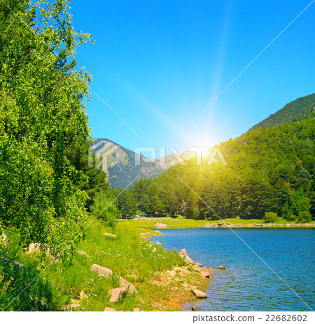 picturesque lake, mountains and blue sky picturesque lake, mountains and blue sky 22682602