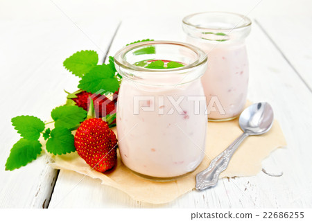 Yogurt with strawberries in jar on the parchment Yogurt with strawberries in jar on the parchment 22686255