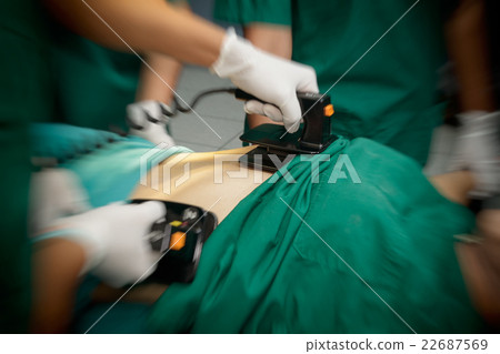 Defibrillator practice on a CPR with motion blur Defibrillator practice on a CPR with motion blur 22687569