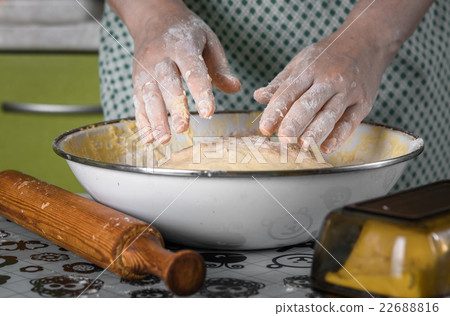 female hands flour kneading dough in white bowl 22688816