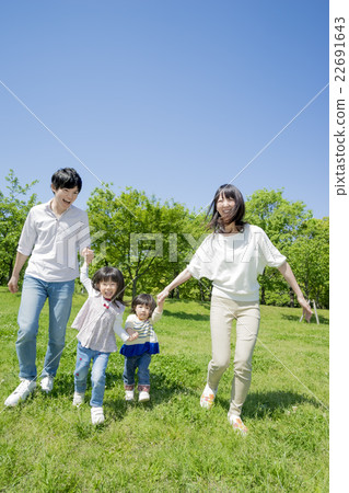 Four people walking in a fresh green park Four people walking in a fresh green park 22691643