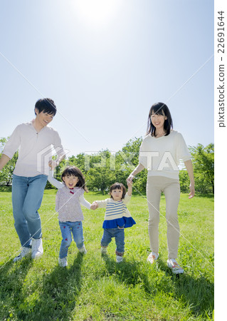 Four people walking in a fresh green park Four people walking in a fresh green park 22691644