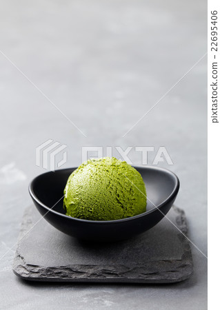 Green tea matcha ice cream scoop in bowl 22695406