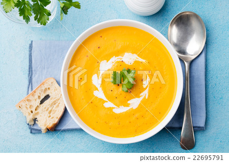 Pumpkin and carrot soup with cream Top view Pumpkin and carrot soup with cream Top view 22695791