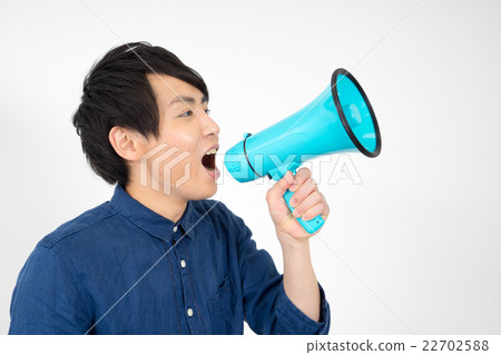 A man shouting at a loudspeaker 22702588