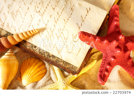 Seashells and old book on sand Seashells and old book on sand 22703974