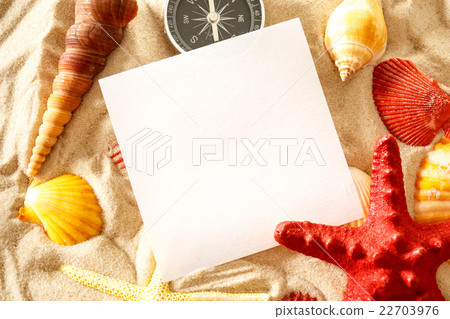Seashells, compass and paper on sand Seashells, compass and paper on sand 22703976