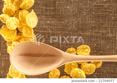 Wooden spoon and corn flakes on sack 22704057