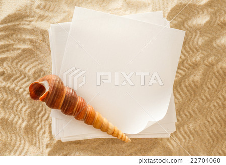 Blank white paper and seashell in sand Blank white paper and seashell in sand 22704060