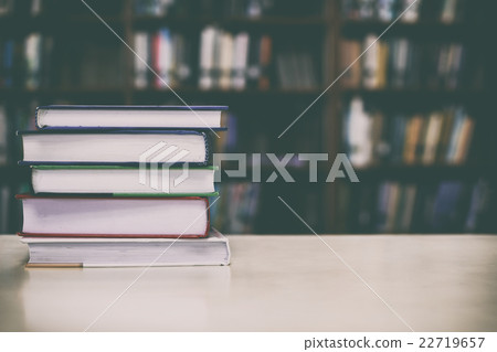 Stack of books on desk with vintage filter Stack of books on desk with vintage filter 22719657