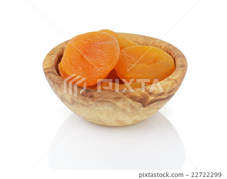 heap of dried apricots in wood bowl heap of dried apricots in wood bowl 22722299