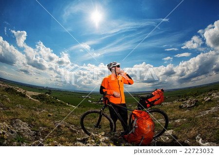 Young Male Cyclist Talking On Cell Phone 22723032
