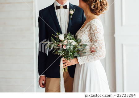 bride and groom together holding wedding bouquet bride and groom together holding wedding bouquet 22723294