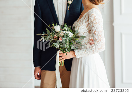 bride and groom together holding wedding bouquet bride and groom together holding wedding bouquet 22723295