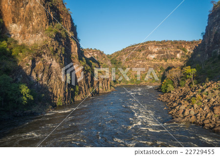 Aerial view of sunlit rapids and canyon 22729455