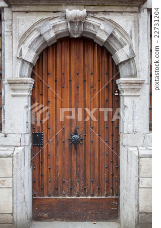 Wooden door with carved stone decorated frame 22731204