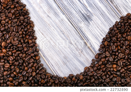 Coffee beans stacked on the old wooden background Coffee beans stacked on the old wooden background 22732890