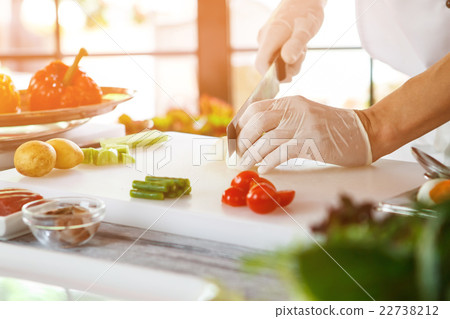 Hand with knife cuts egg. Hand with knife cuts egg. 22738212