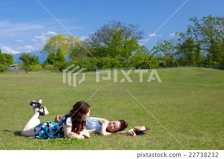 Two women who relax on the lawn 22738232
