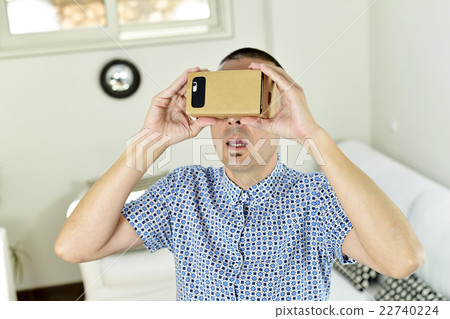 young man with cardboard virtual reality lenses young man with cardboard virtual reality lenses 22740224