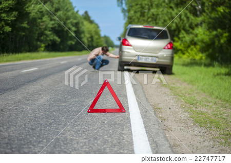 Car after breakdown on the road and triangle sign Car after breakdown on the road and triangle sign 22747717