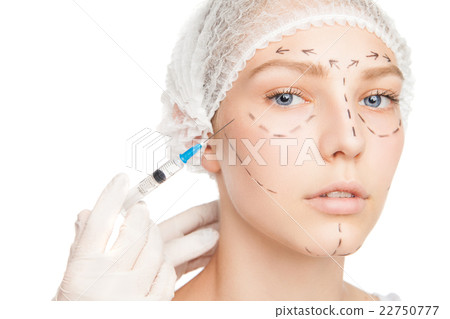 Surgeon injecting woman's face with outlines Surgeon injecting woman's face with outlines 22750777