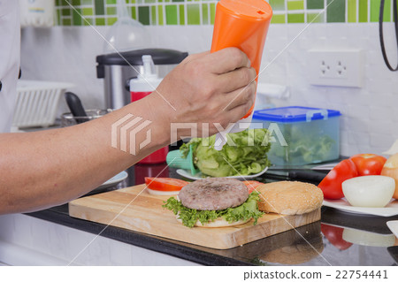 Chef putting mayonnaise on the Hamburger bun 22754441