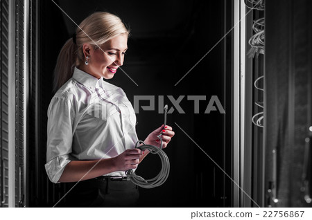 Young engineer businesswoman in server room 22756867