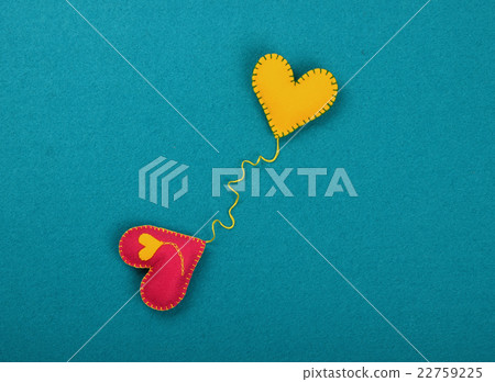 Two felt craft hearts, pink and yellow on blue Two felt craft hearts, pink and yellow on blue 22759225