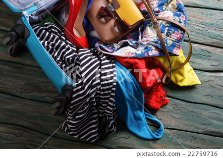 Crumpled clothes in blue suitcase. Crumpled clothes in blue suitcase. 22759716