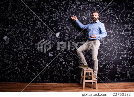 Man writing on big blackboard with mathematical Man writing on big blackboard with mathematical 22760182