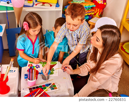 Children with teacher woman painting on paper in Children with teacher woman painting on paper in 22760831