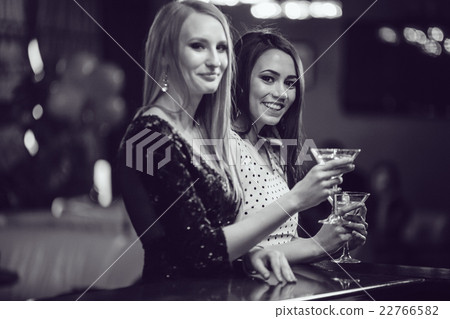 Beautiful girls having fun at a party in nightclub 22766582