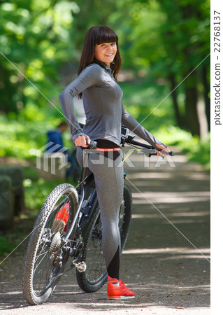 cyclist woman riding a bicycle in park 22768137