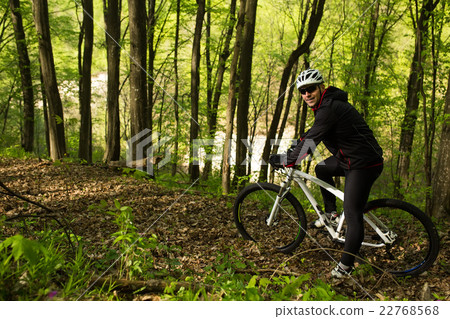 Cyclist Riding the Bike on a Trail in Summer Cyclist Riding the Bike on a Trail in Summer 22768568