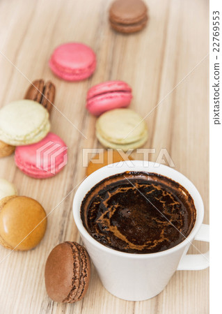 Cup of black coffee with french colorful macarons, sweet delight 22769553