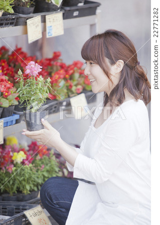 A woman shopping at a gardening store 22771282