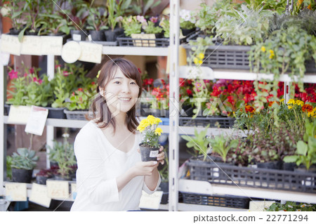 A woman shopping at a gardening store 22771294