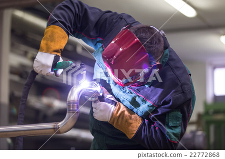 Industrial worker welding in metal factory. 22772868