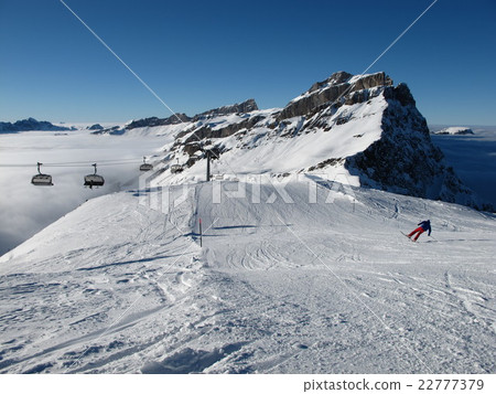 Mountain, sea of fog and staggering skier Mountain, sea of fog and staggering skier 22777379